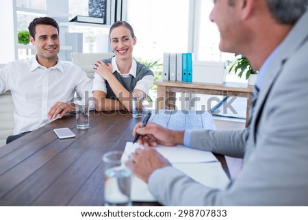 Casual business people speaking together in office
