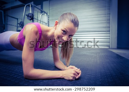 Portrait of a muscular woman on a plank position