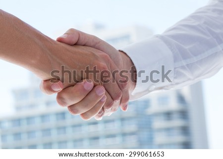 Close up view of two business people shaking hands in the office
