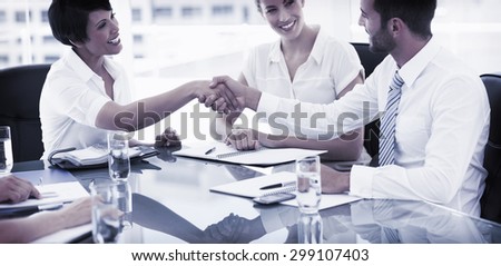 Side view of executives shaking hands after a business meeting in the office