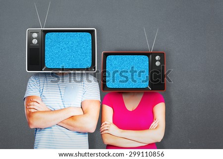 Young couple with bags over heads against grey background