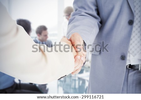 People in suit shaking hands against business people in board room meeting