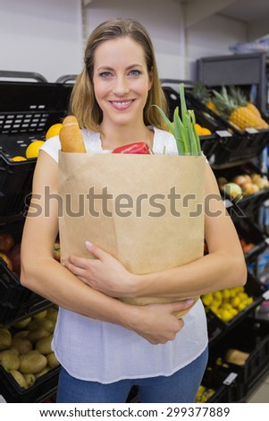 A pretty blonde with a grocery bag in the supermarket