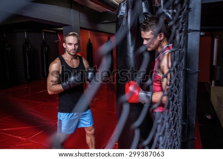 Portrait of boxing men training on a pushing ball