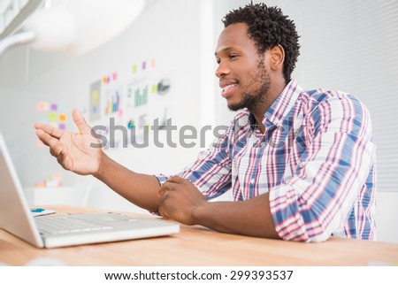Young businessman sits in front of the laptop in the office