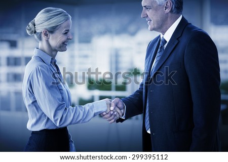 Business people shaking hands against office