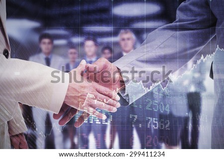 Close up of business people shaking their hands against stocks and shares