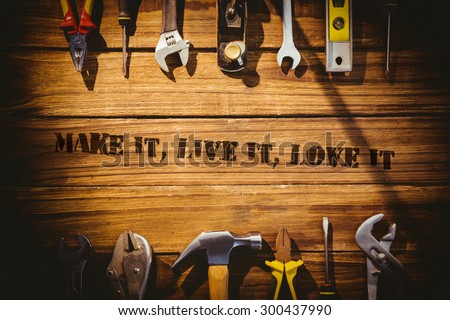 The word make it, live it, love it against desk with tools