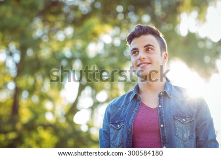 Handsome hipster looking to the distance on a sunny day