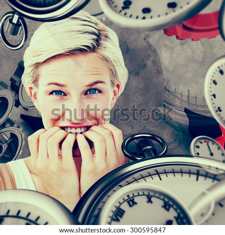 Nervous woman biting her nails looking at camera against grey background