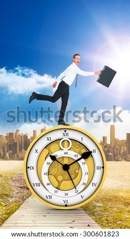 Happy businessman leaping with his briefcase against path on grass with cityscape on horizon