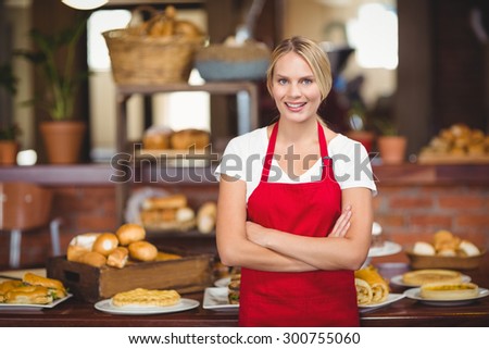 Portrait of a waitress with arms crossed at the coffee shop