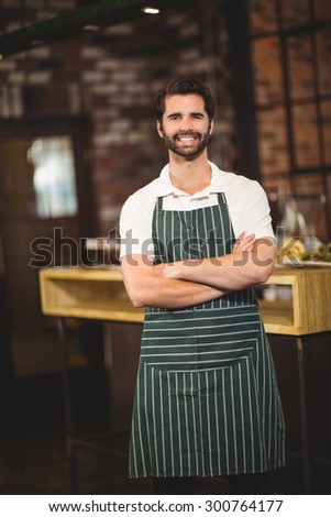 Portrait of a barista with arms crossed at the coffee shop