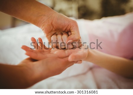 Young woman getting hand massage in therapy room