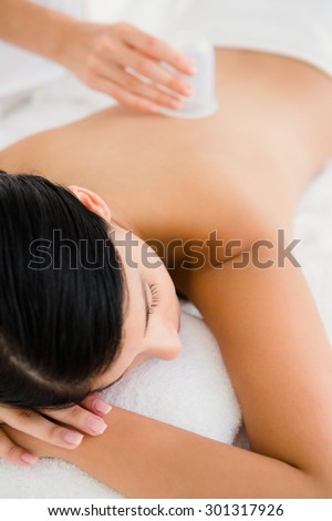 Beautiful brunette with vacuum cups on her back at the health spa