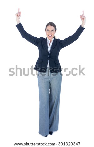 Portrait of a businesswoman doing a victory pose against a white background