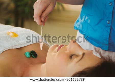 Young woman at crystal healing session in therapy room