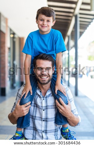 Portrait of a father and son piggybacking at the mall