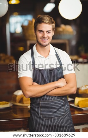 Portrait of a waiter with arms crossed at the coffee shop