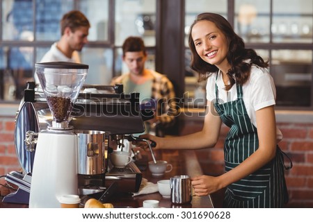 Portrait of a barista making a cup of coffee at the coffee shop