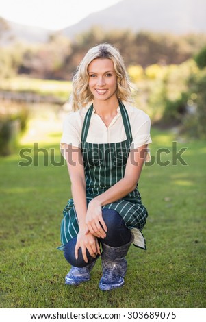Portrait of a kneeling farmer woman with an apron
