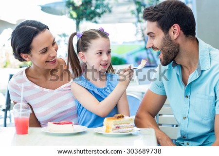 A family eating at the restaurant on a sunny day