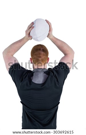 Rear view of a rugby player about to throw a rugby ball