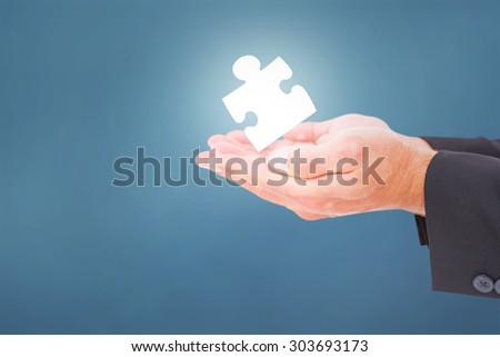 Businessman holding his hands out against blue background