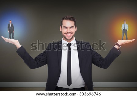 Serious businessman standing with hands in pockets against room with wooden floor