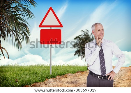 Businessman thinking against hazard signs beside trail