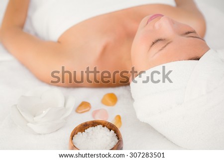 Relaxed woman lying on the massage table at the health spa