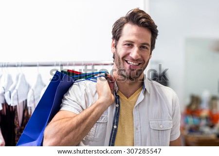 Portrait of smiling man with shopping bags