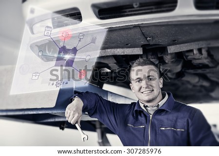 Engineering interface against mechanic holding a spanner below a car