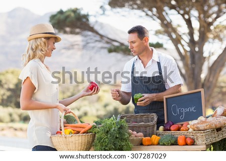 Farmer discussing with a customer at the local market