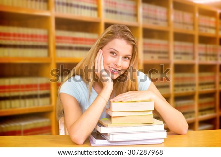 Portrait of female student in library against close up of a bookshelf