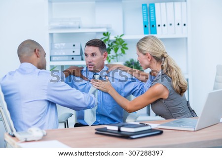Business partners fighting together in the office