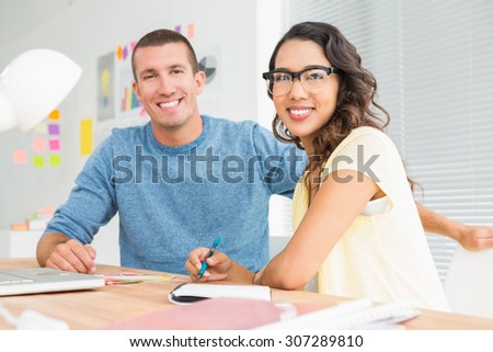 Portrait of smiling colleagues looking at camera in the office