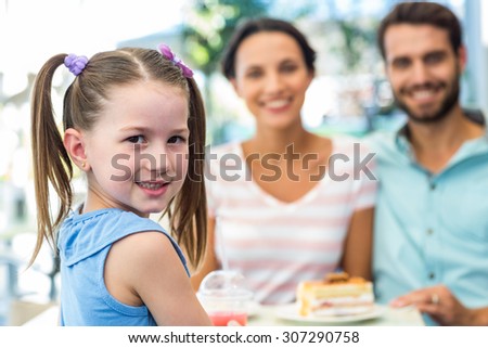Portrait of a family eating at the restaurant on a sunny day
