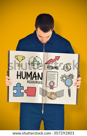 Manual worker showing a book against yellow background with vignette