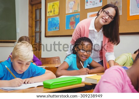 Teacher and student smiling together at the elementary school
