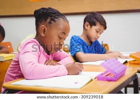 Students sitting and doing class work at the elementary school