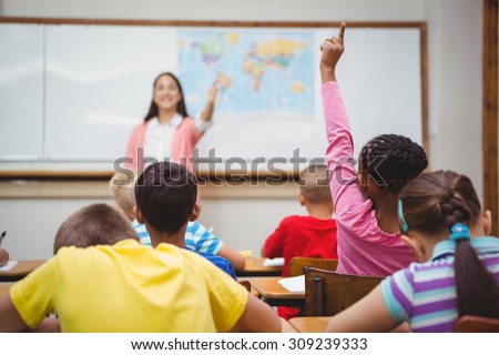 Student raising hand to ask a question at the elementary school