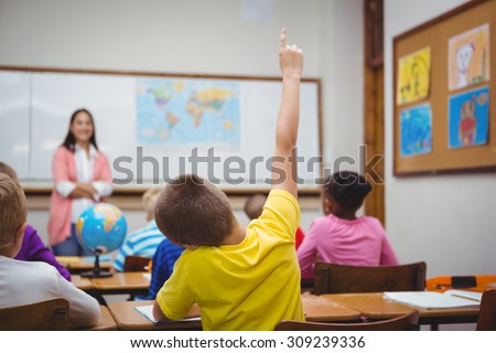 Student raising hand to ask a question at the elementary school