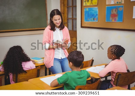 Teacher reading out loud to classroom at the elementary school