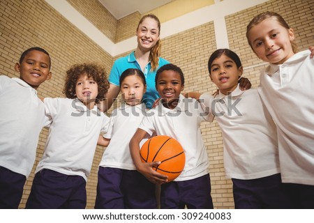 Students and teacher looking at the camera at the elementary school