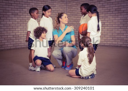 Teacher talking with sports students at the elementary school