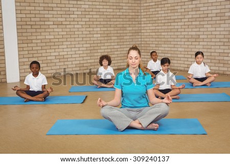 Students and teacher doing yoga pose at the elementary school