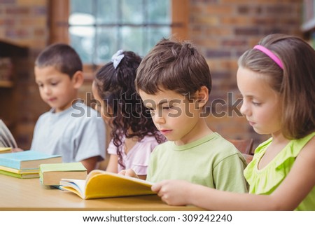 Pupils reading books in library at the elementary school