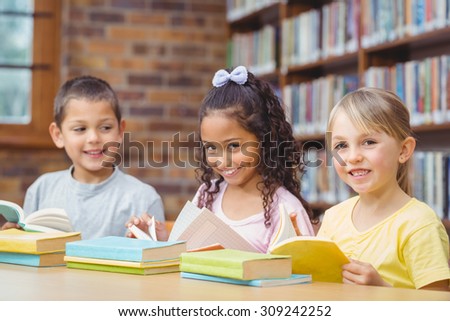 Pupils reading books in library at the elementary school
