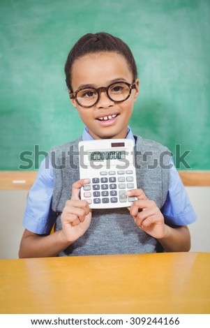 Smart student holding a calculator at the elementary school